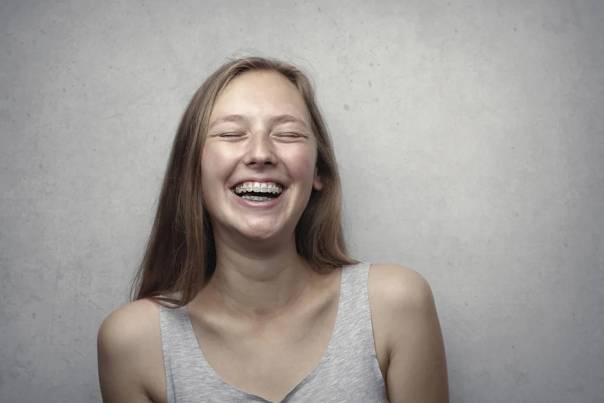 A young woman laughing joyfully.