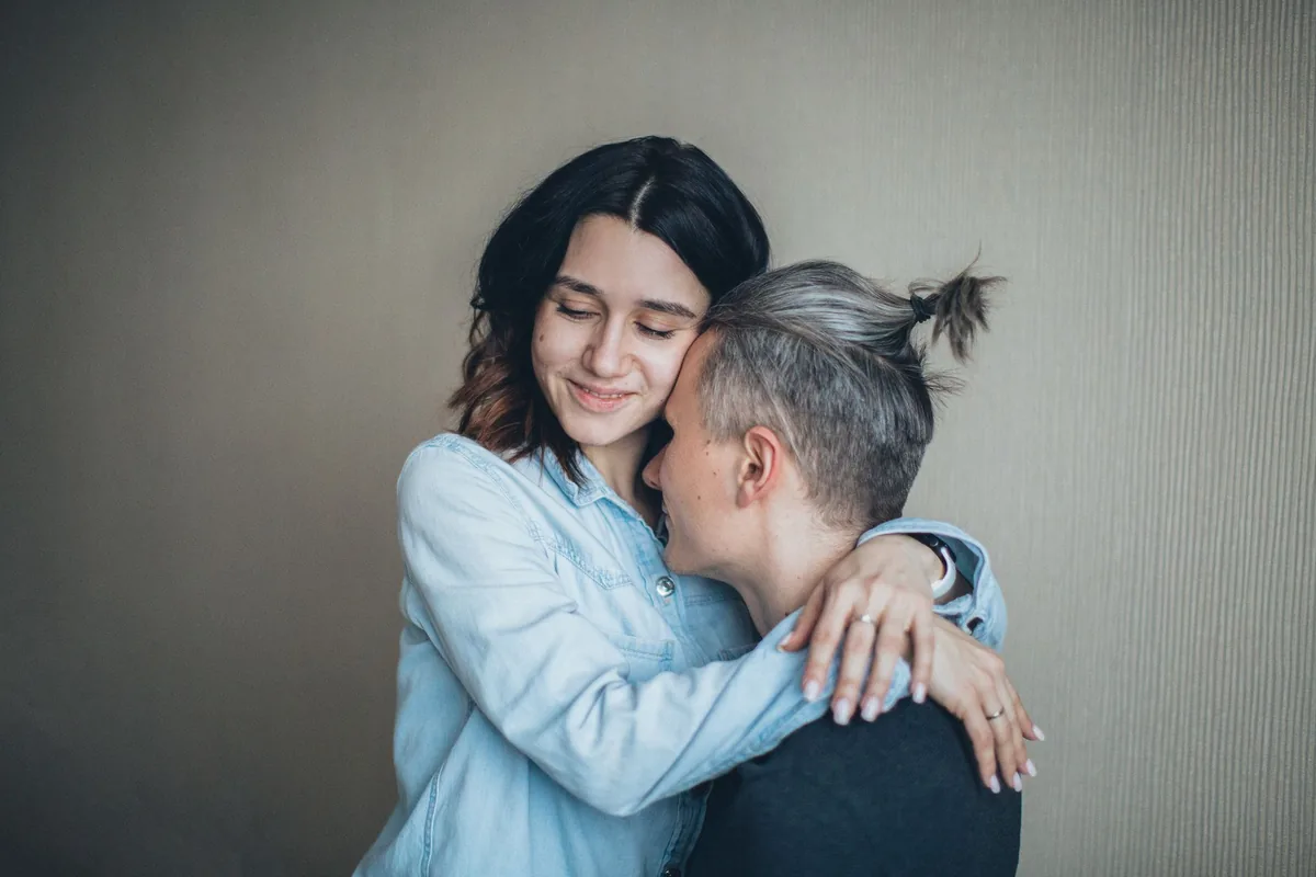 A couple sharing a loving hug indoors.