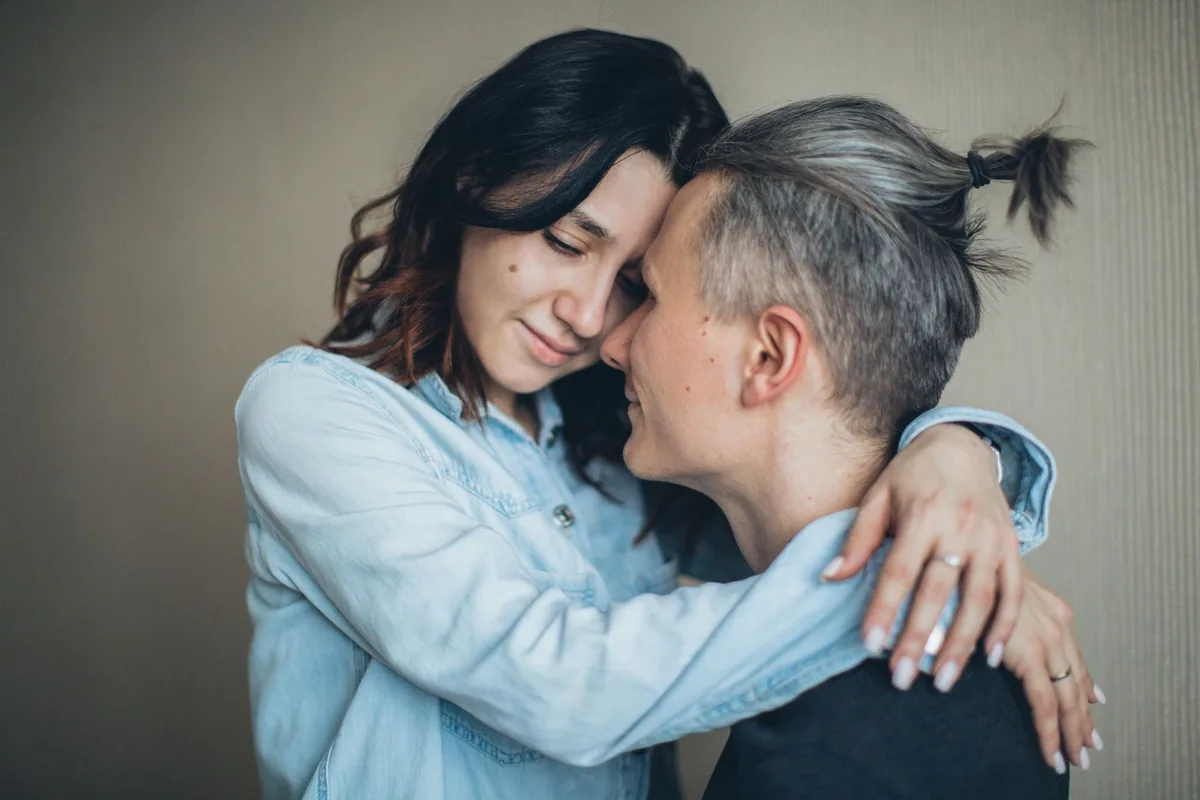 A couple embracing in a tender, affectionate moment.