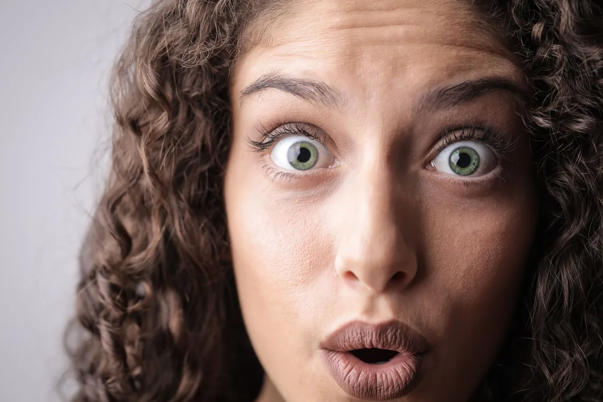 A woman with a surprised, wide-eyed expression.